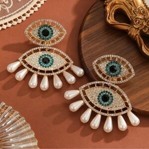 Elegant Gold and Pearl Eye Earrings